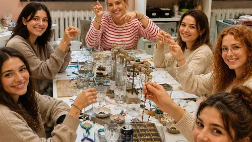 Group of women making jewelry at table.