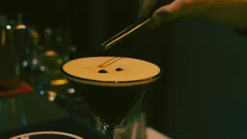 Espresso martini garnished with coffee beans.