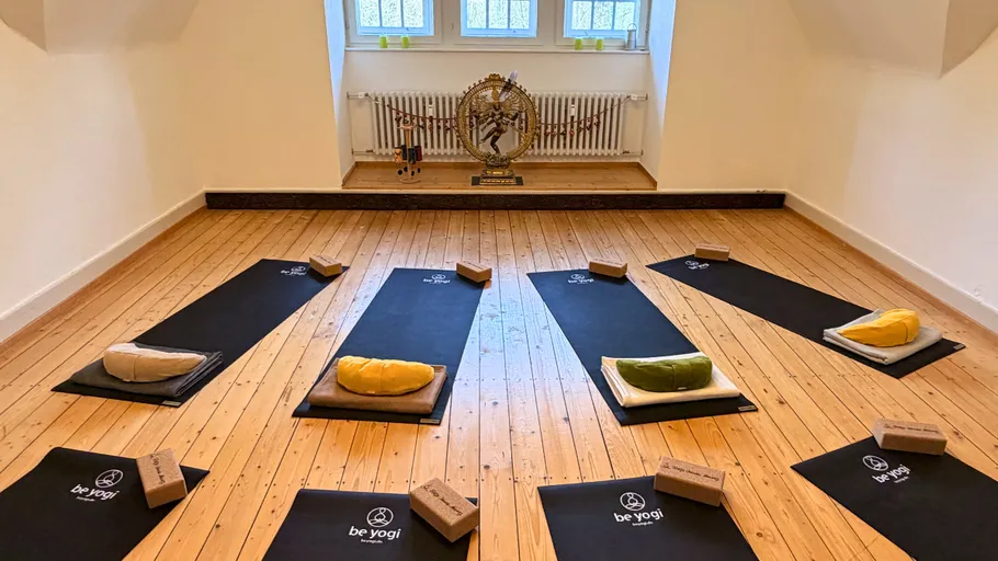 Yogamatten im Raum mit Fenstern angeordnet.