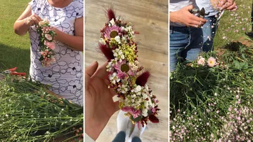 Person making and holding floral arrangement outdoors.