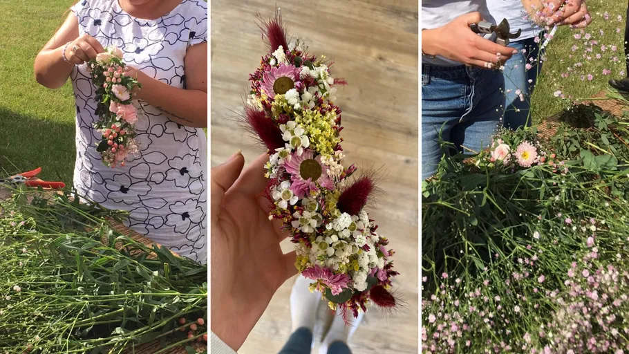 Person making and holding floral arrangement outdoors.