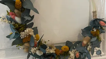 Dekorativer Kranz mit bunten Trockenblumen.