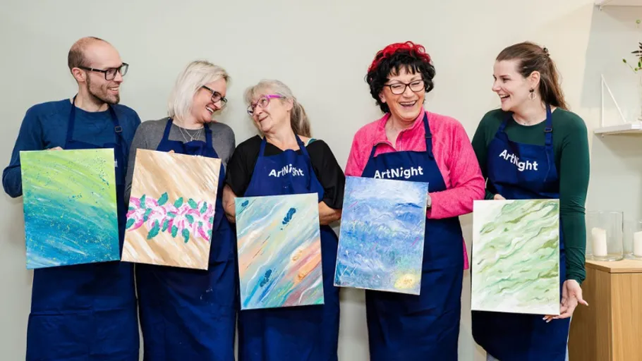 Five people showcasing abstract paintings indoors.