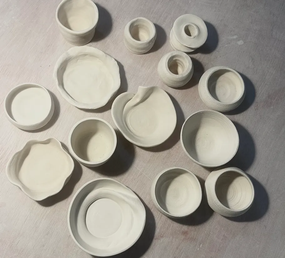 Various handmade clay pots on a surface.