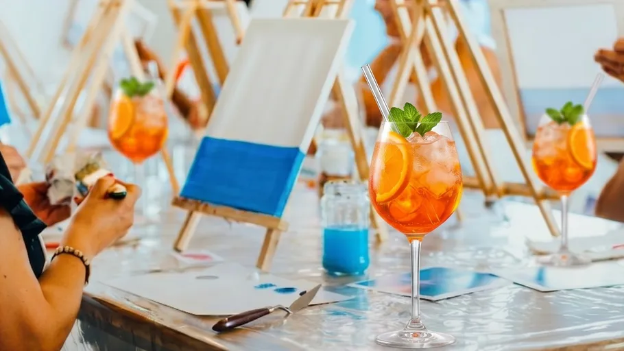 People painting with cocktails in an art class.