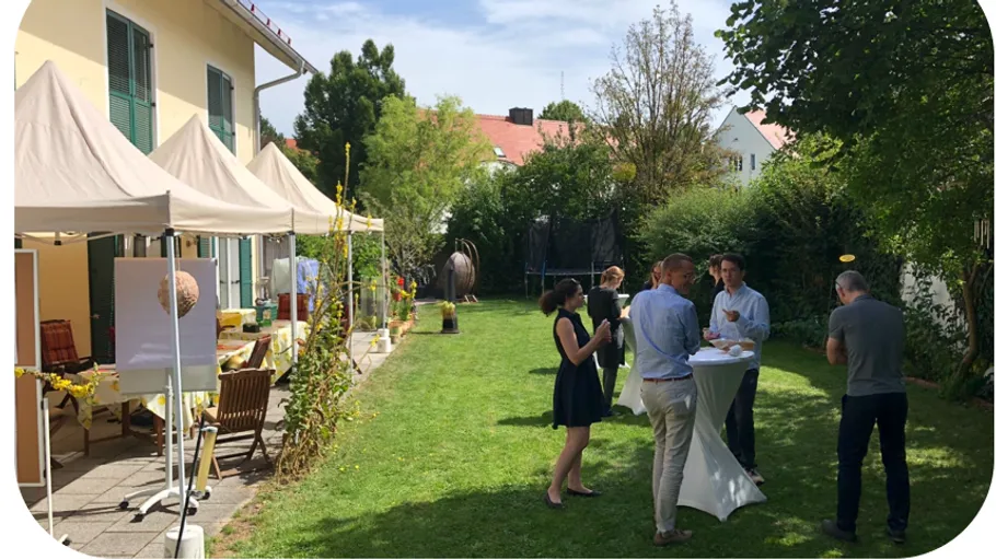 People socializing in a sunny garden.