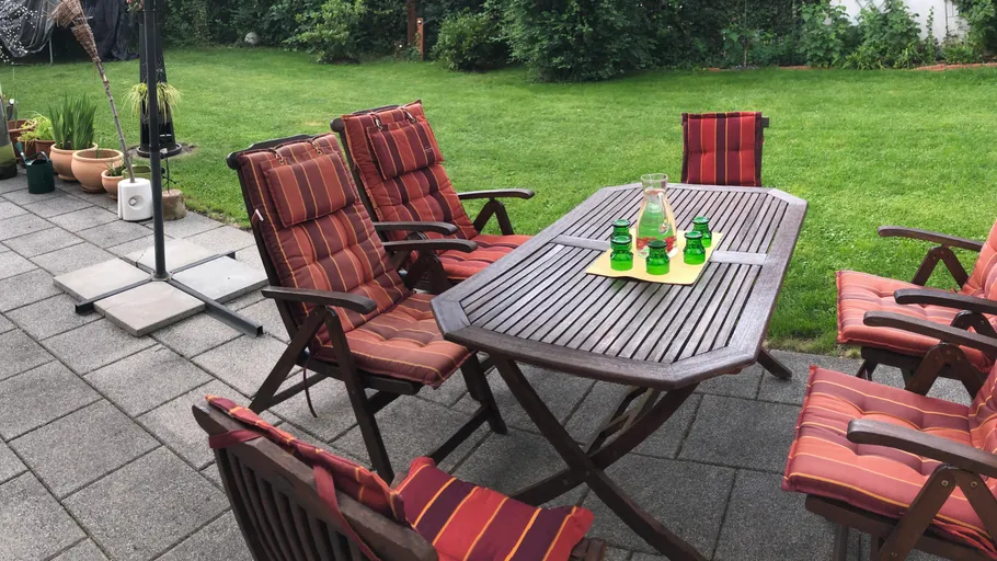 Patio furniture set on stone terrace.