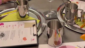 Close-up of workshop table with steel mugs.