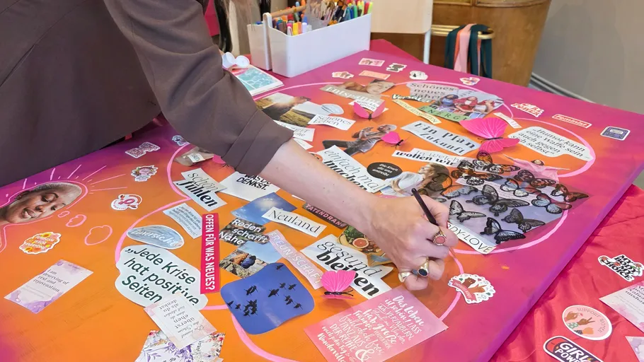 Person creating a colorful vision board indoors.