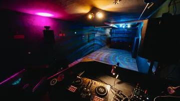 DJ booth with colorful lights in a club.