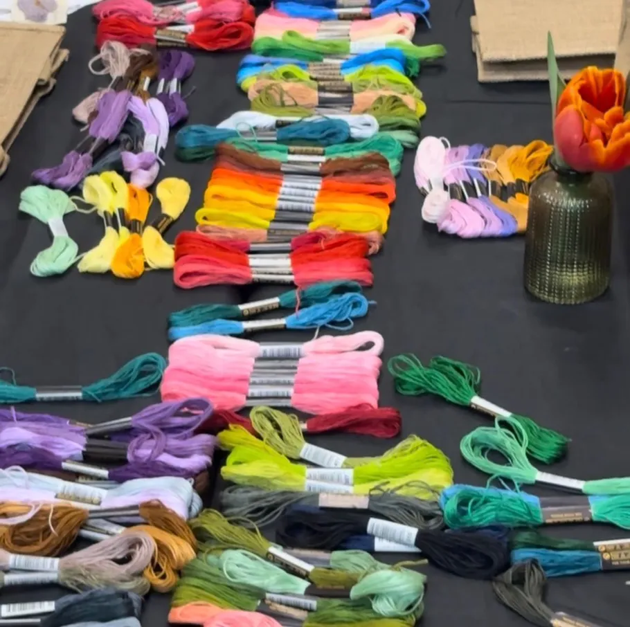 Colorful embroidery threads laid out on table.