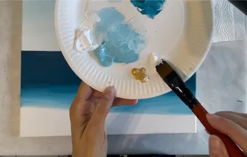 Hands painting with palette and brush.