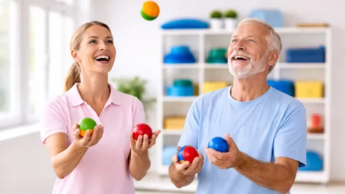 Two people joyfully juggling colorful balls indoors.