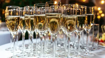 Mit Champagner gefüllte Gläser auf einem Tisch.