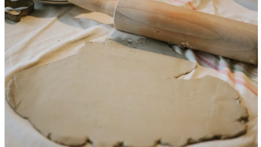 Rolled clay and rolling pin on cloth.