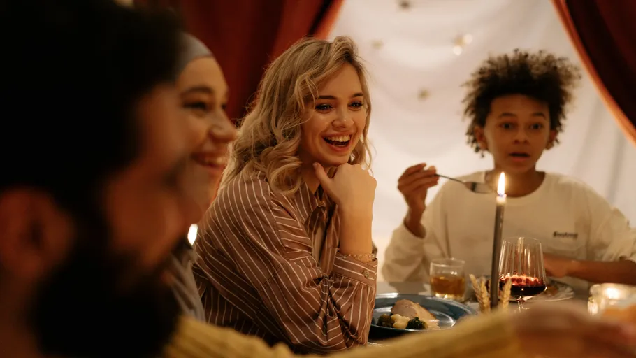 Smiling group at a dinner table.