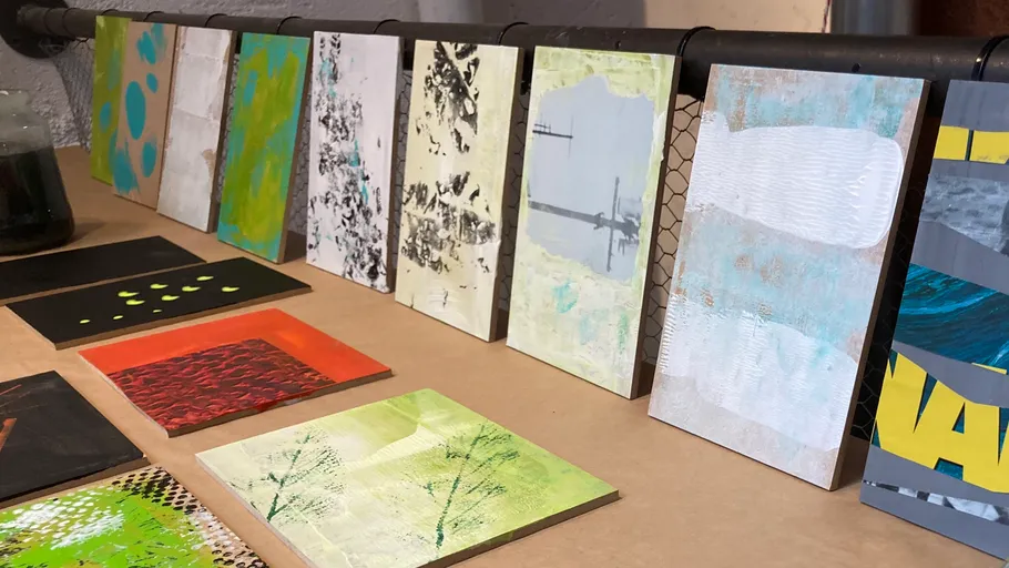 Abstract paintings displayed on a table.