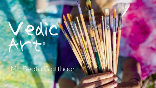 Hands holding paintbrushes, colorful background.