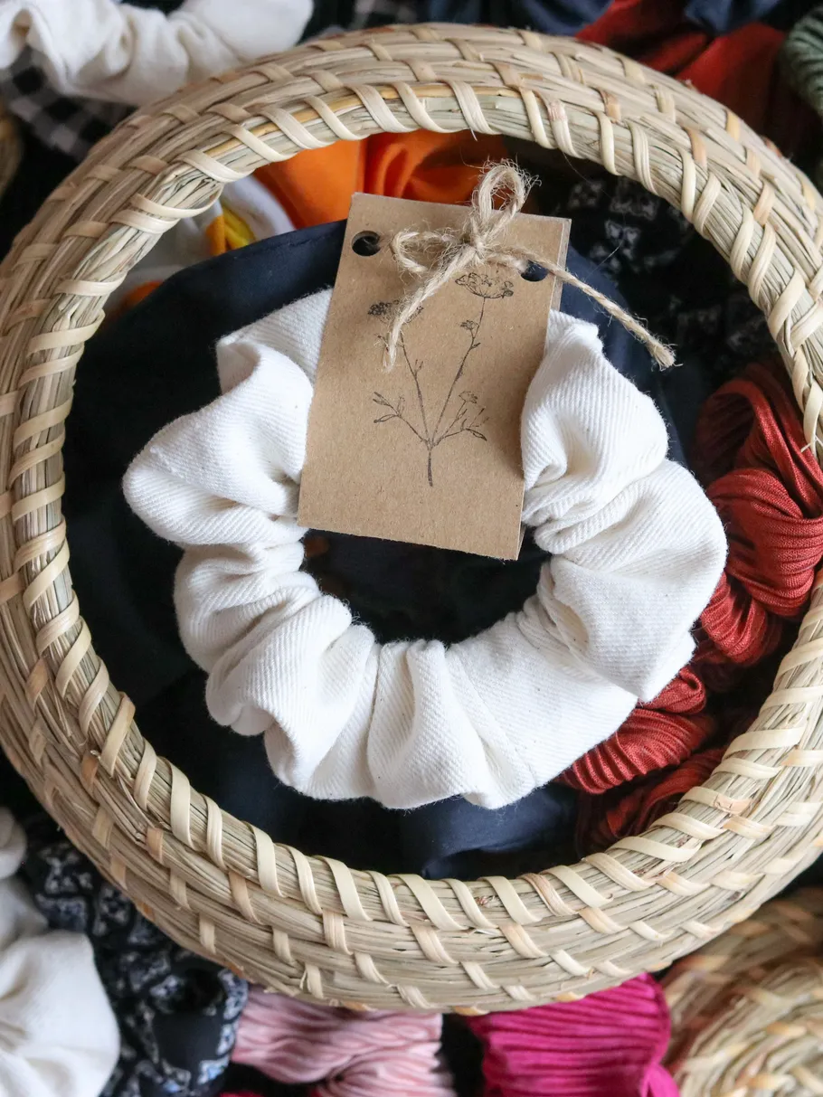 White scrunchie in a woven basket.