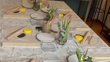 Art supplies arranged on a decorated table.