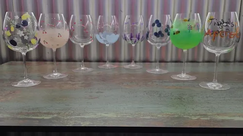 Decorated wine glasses on a wooden table.