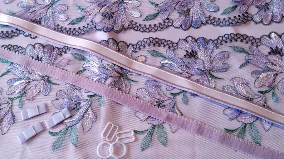Floral lace fabric with ribbons and clips.