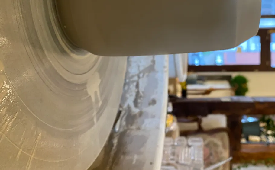 Pottery wheel spinning in a workshop.