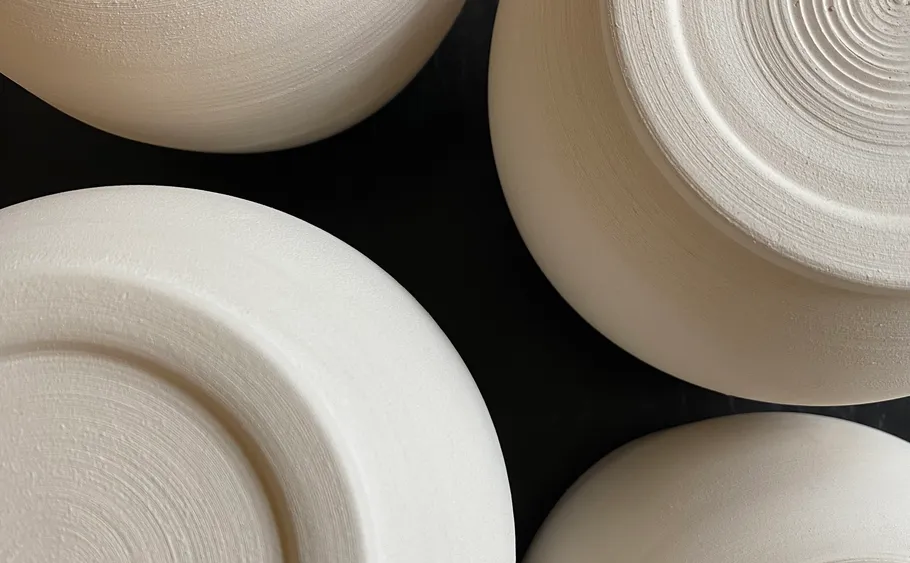 Close-up of four ceramic bowls' bases.
