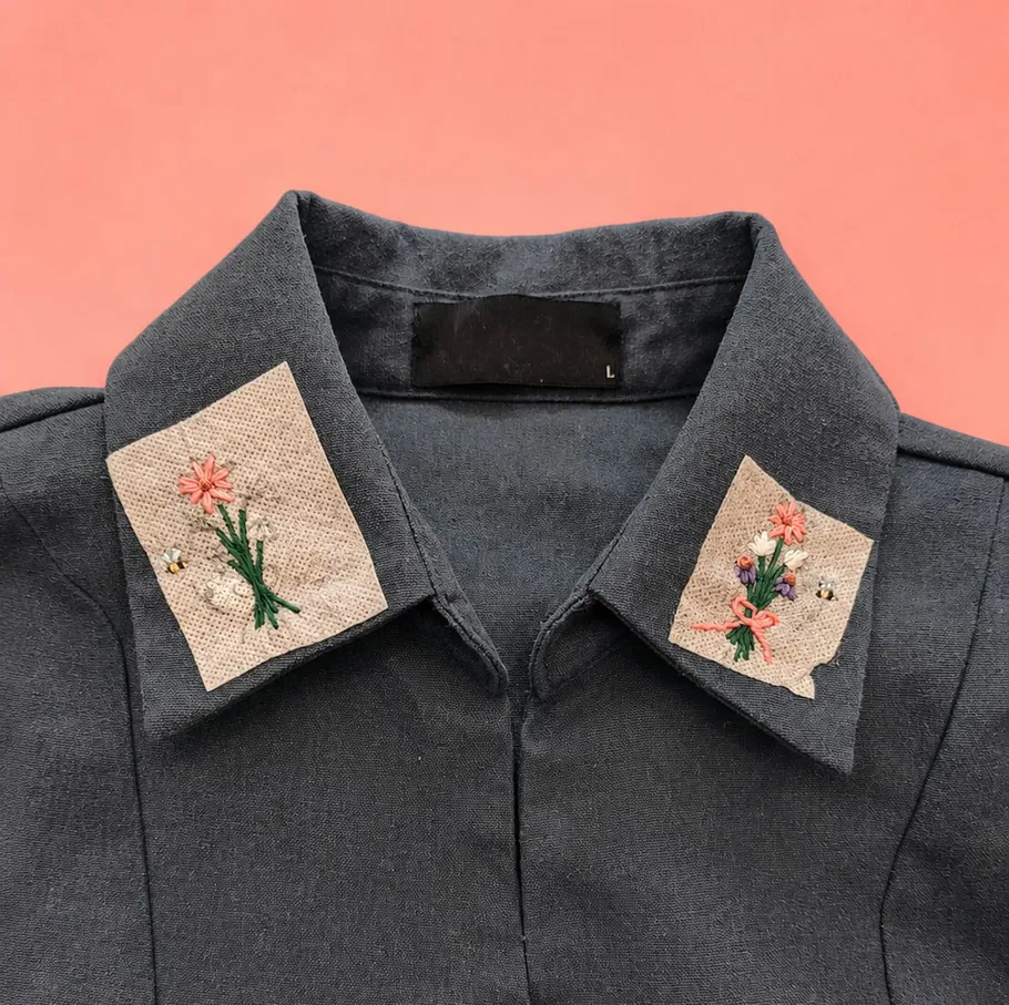 Shirt collar with embroidered patches, red background.