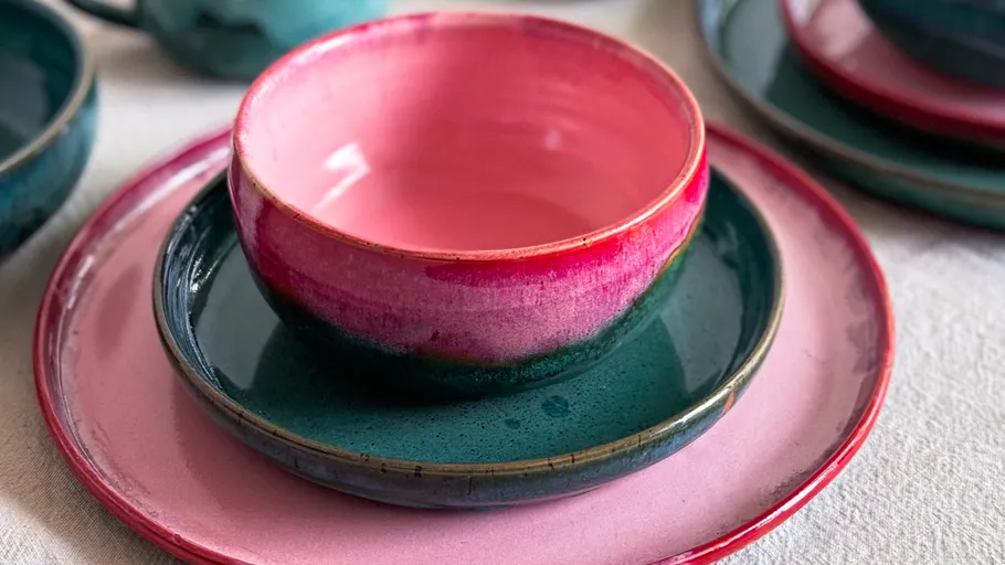 Colorful ceramic bowl on matching plates.