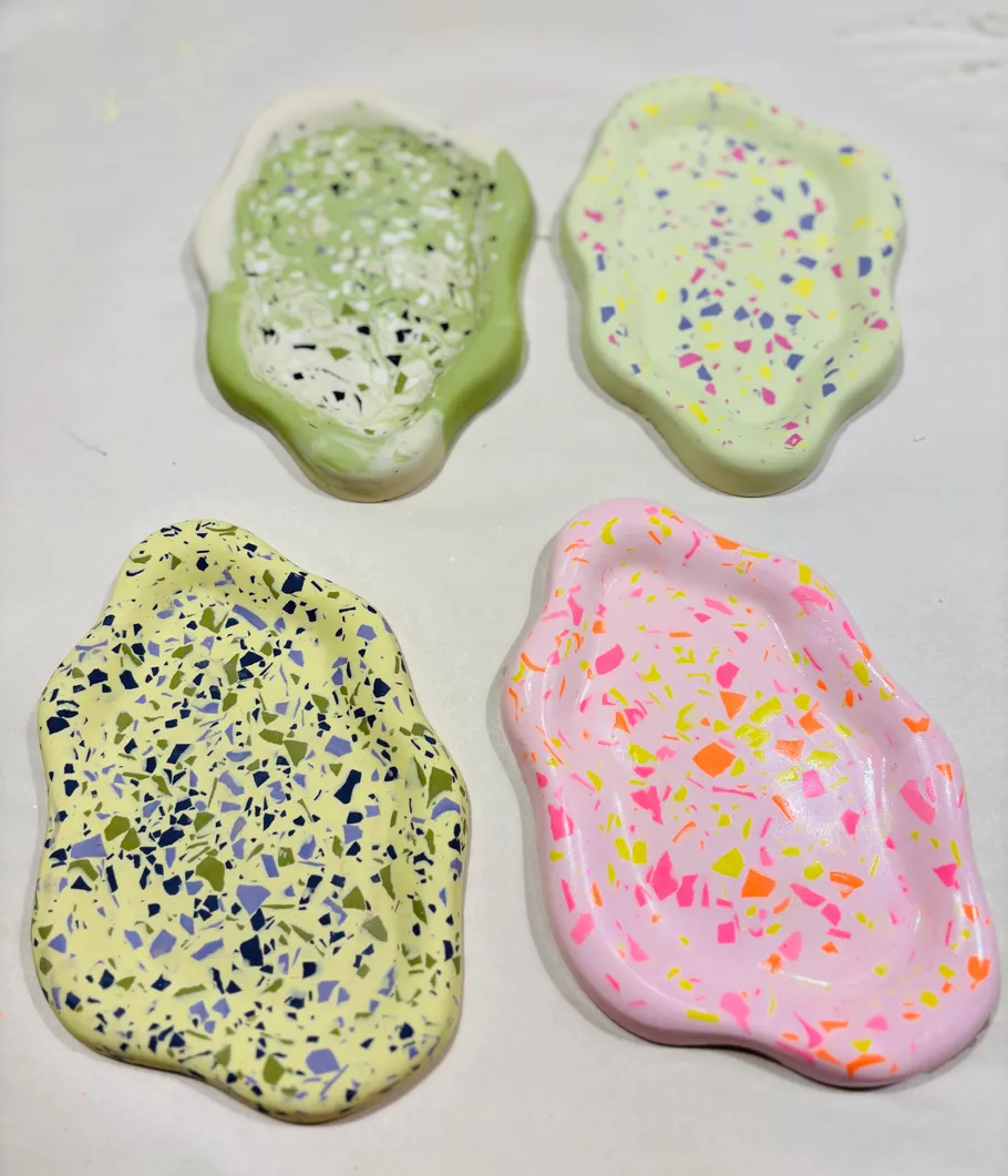 Colorful, irregularly-shaped decorative dishes on a surface.