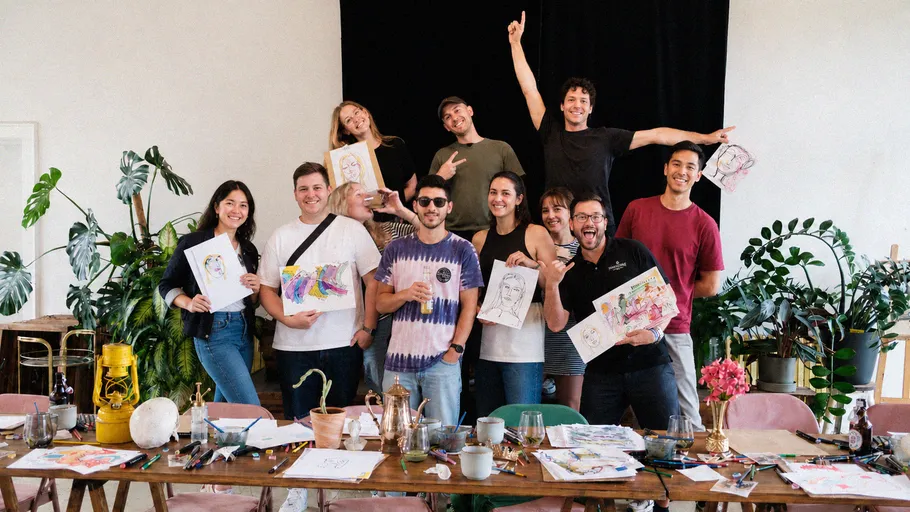 Group posing with artwork in a studio setting.