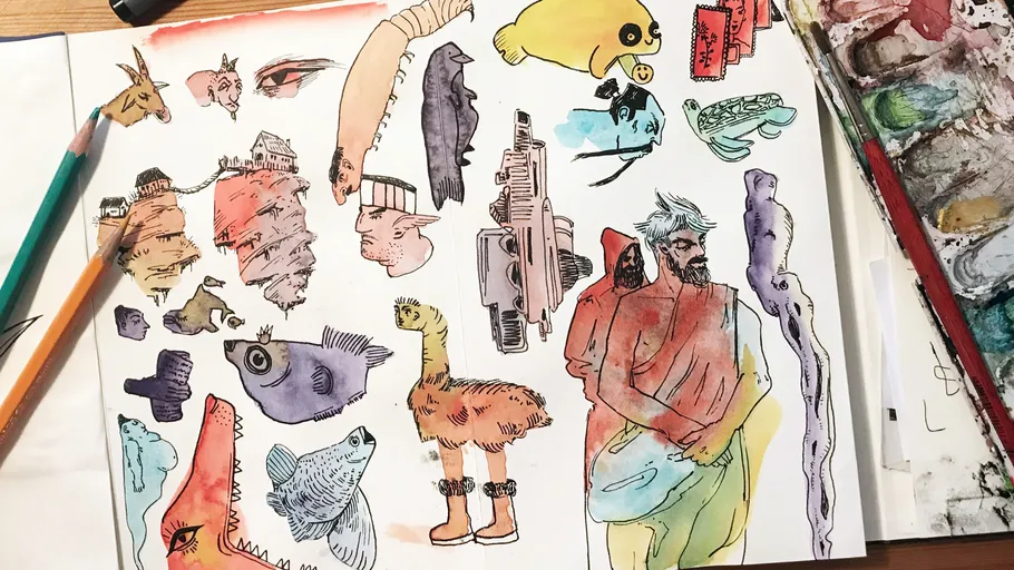 Colorful abstract sketches on paper with pencils nearby.