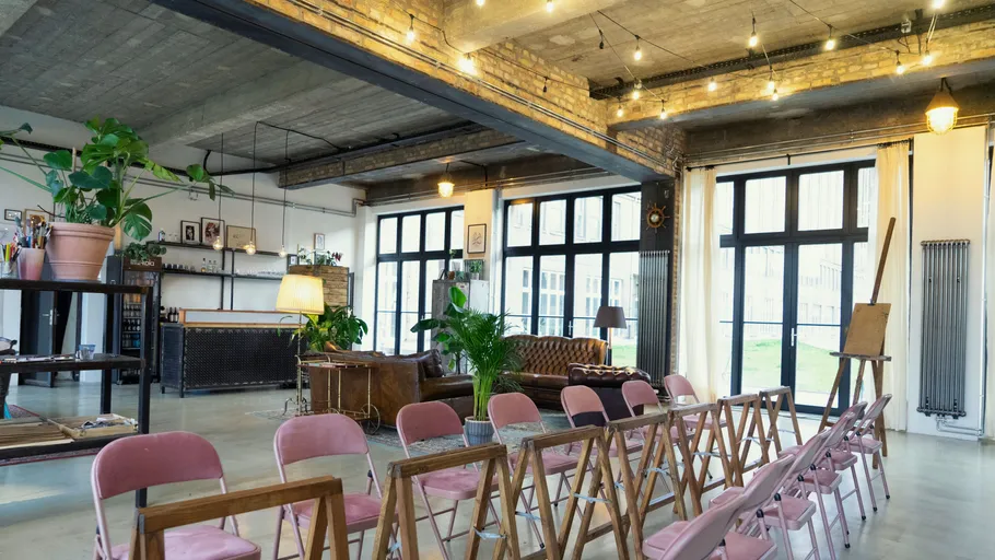 Open loft with chairs and plants, workshop setup.