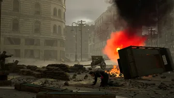 Soldier kneeling in war-torn city street.
