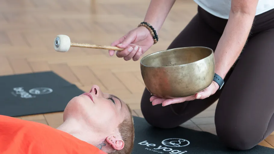 Person verwendet Klangschale bei Meditationssitzung.