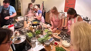 People cooking together in a kitchen.