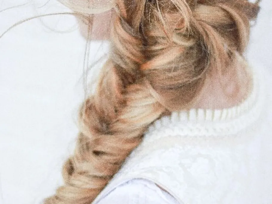 Braided hairstyle on long blond hair against a light background.