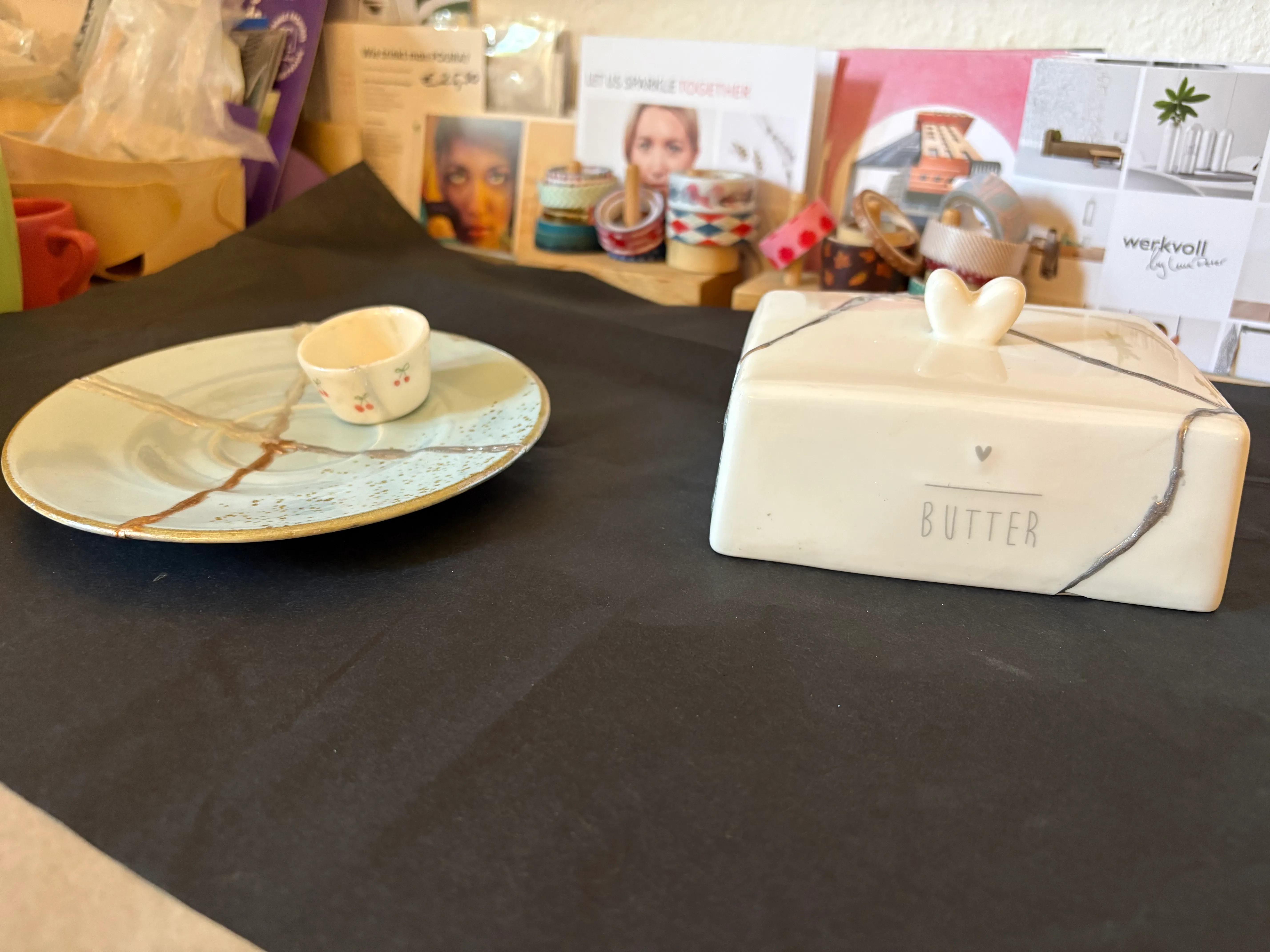 Ceramic butter dish and plate on a table.