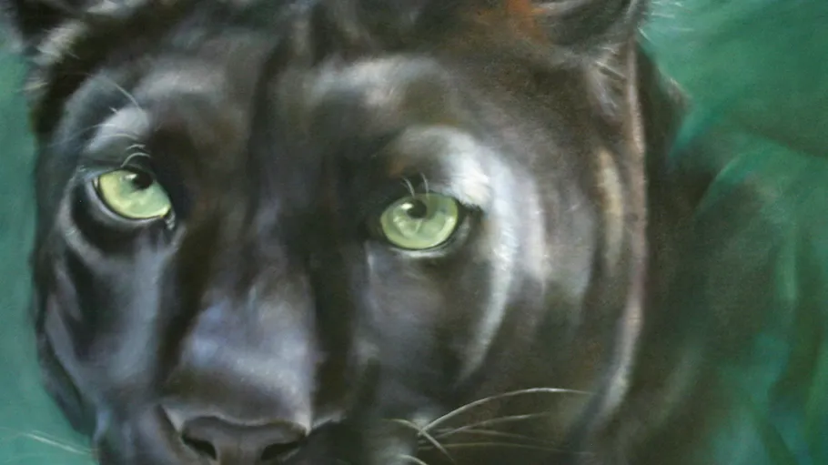 Black panther close-up with green eyes.