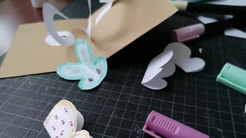 Handmade card with hearts on a desk.