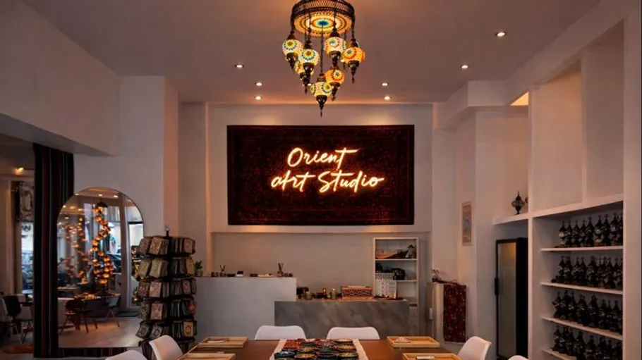 Art studio with vibrant lamps and signage.
