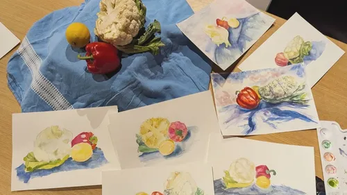 Vegetables arranged on cloth with watercolor paintings.