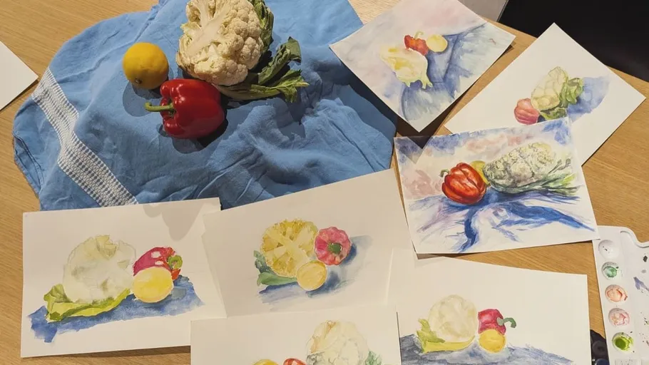 Vegetables arranged on cloth with watercolor paintings.