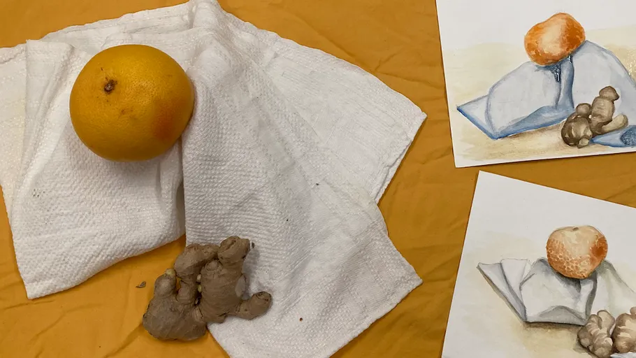 Orange and ginger on white cloth next to paintings.