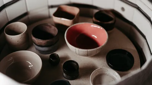 Ceramic bowls inside a kiln, ready for firing.