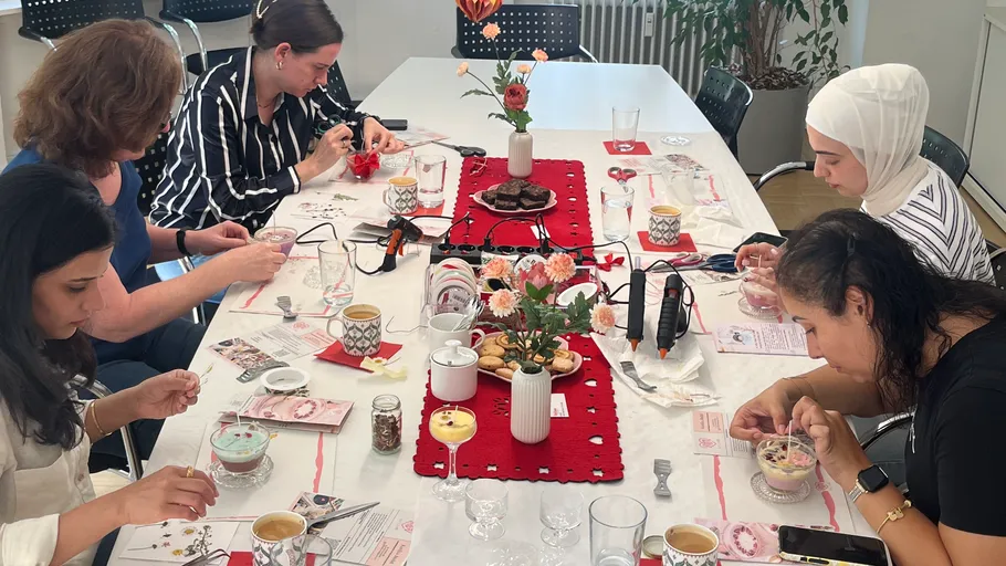 Women crafting at decorated table indoors.