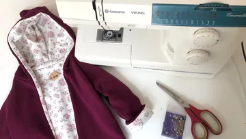 Sewing machine next to a handmade jacket.