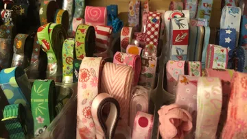 Colorful ribbons neatly organized in containers.