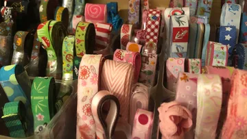 Colorful ribbons neatly arranged in containers.